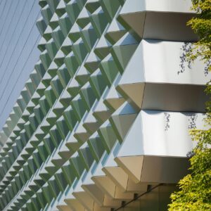Close-up of modern geometric building facade with sunlight in Dresden, Germany.