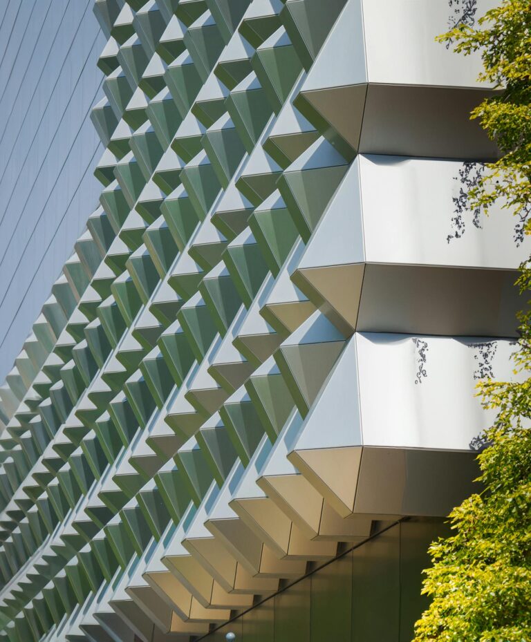 Close-up of modern geometric building facade with sunlight in Dresden, Germany.